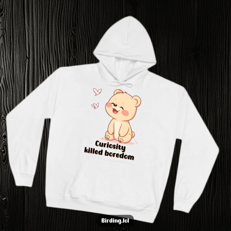 Funny bear cub hoodie illustrated with a joyful cub looking up, giggling at a distant, strange shape soaring through the clouds.